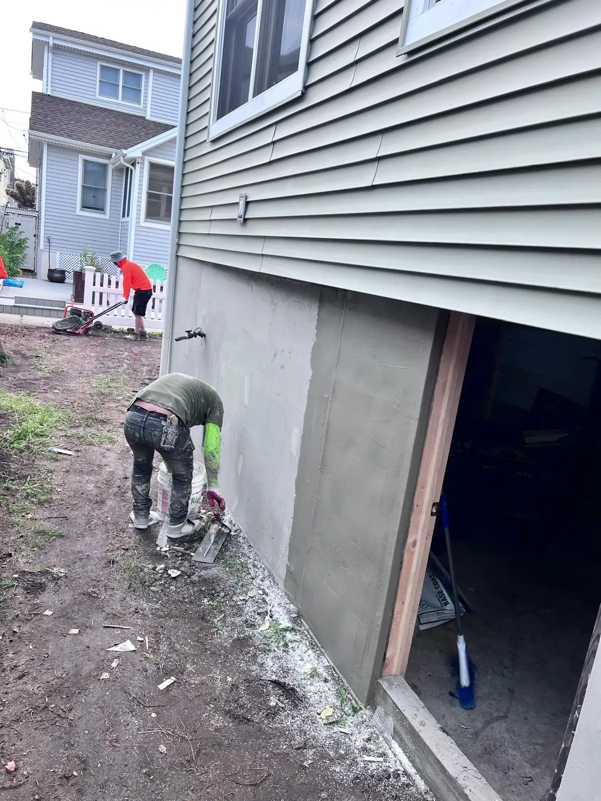 Applying stucco on foundation wall — East Meadow, Long Island