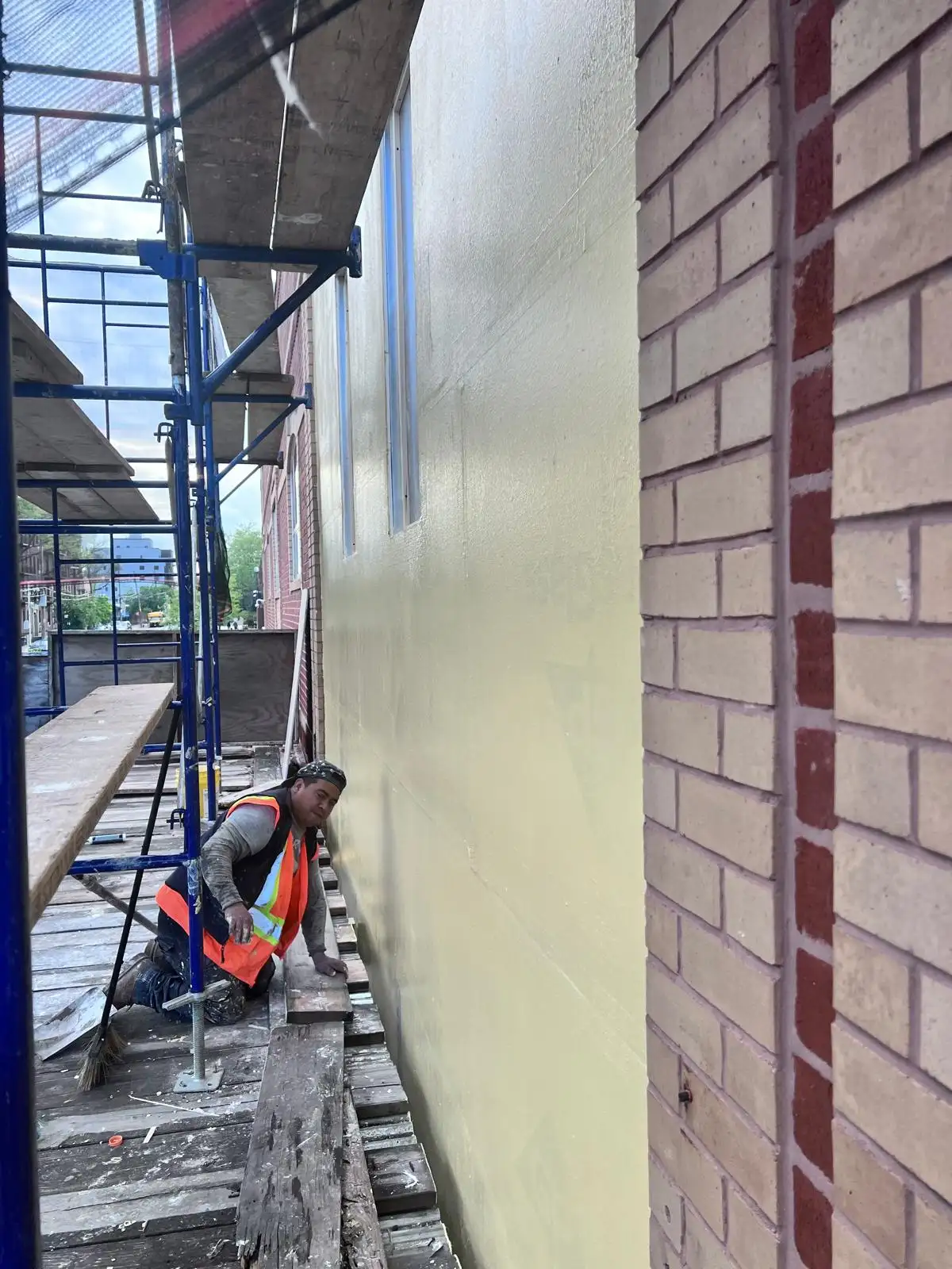 Applying stucco on scaffold — Crown Heights, Brooklyn