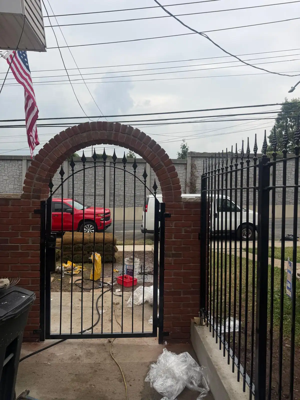 Brick arch and iron gate from street — Emerson Hill, Staten Island