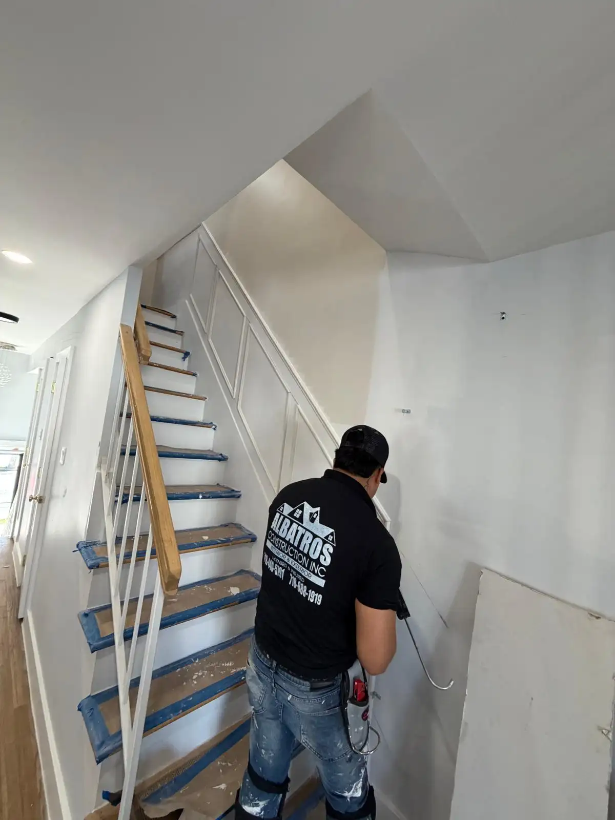 Carpenter fitting staircase molding panels — Bath Beach, Brooklyn