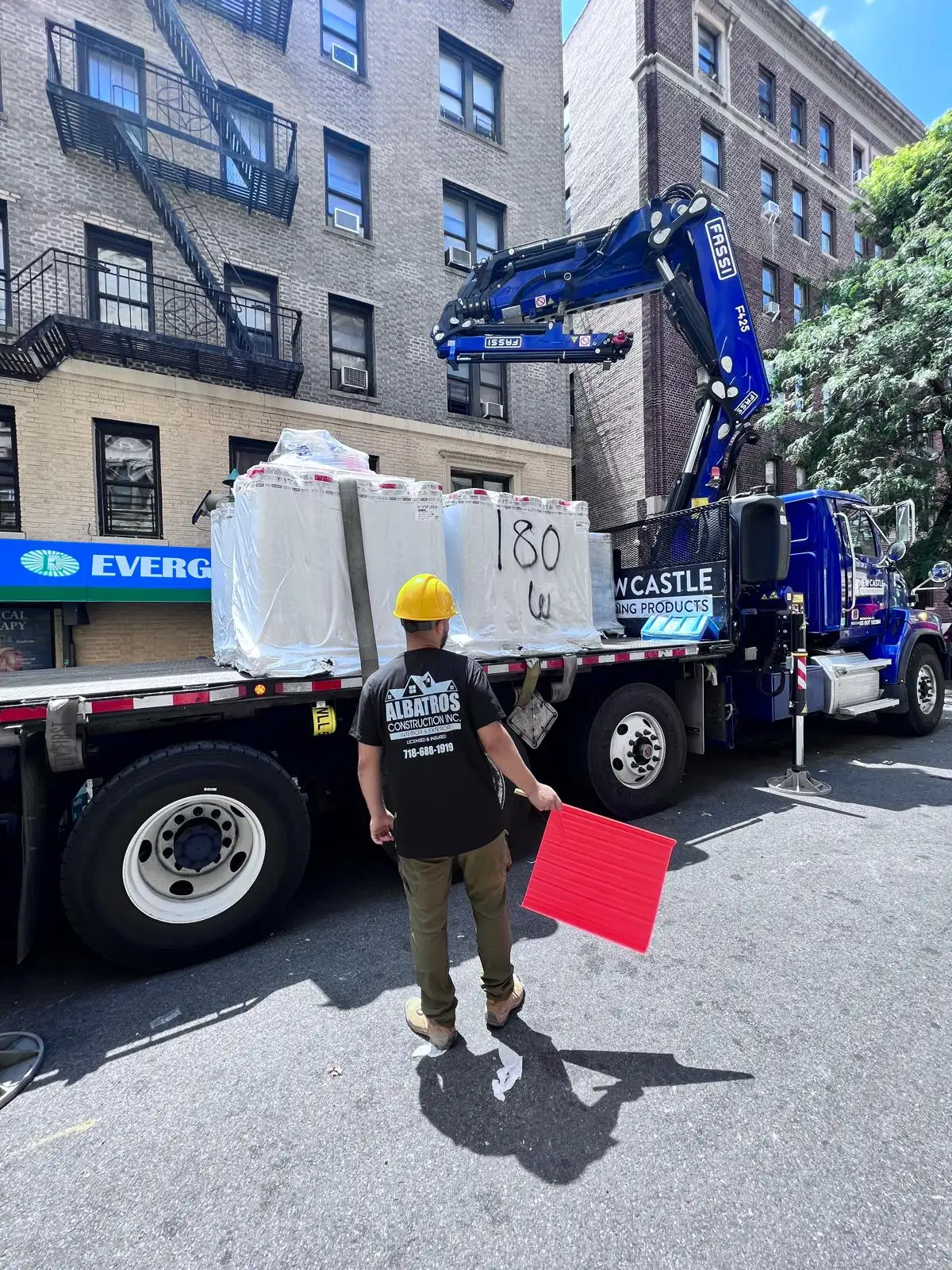 Crane delivering roofing materials — Washington Heights, Manhattan