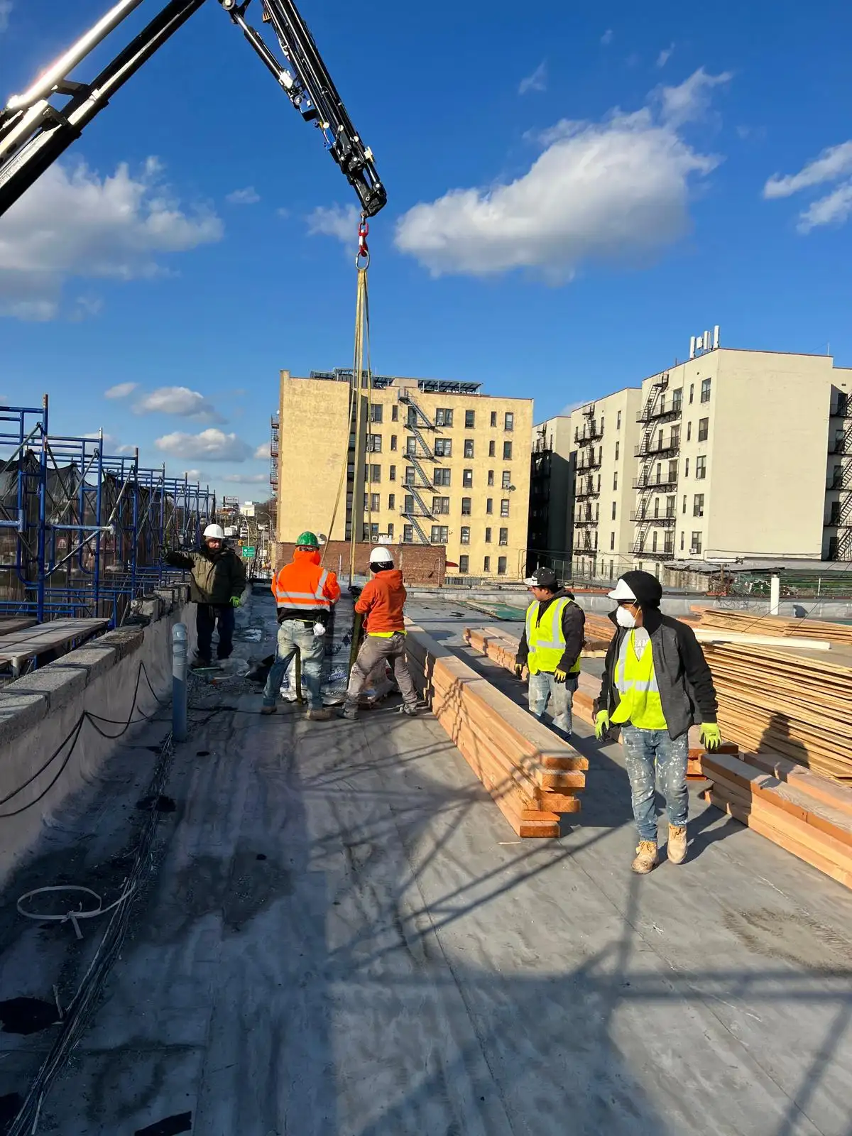 Crane lifting roofing materials — Hunts Point, Bronx