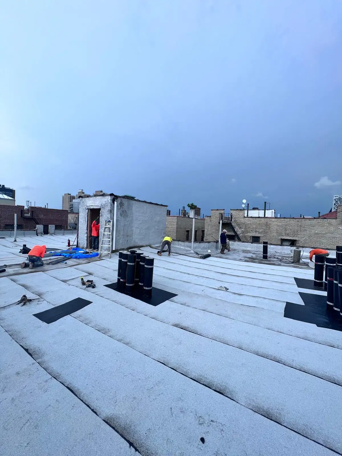 Crew finishing roof flashing — Washington Heights, Manhattan