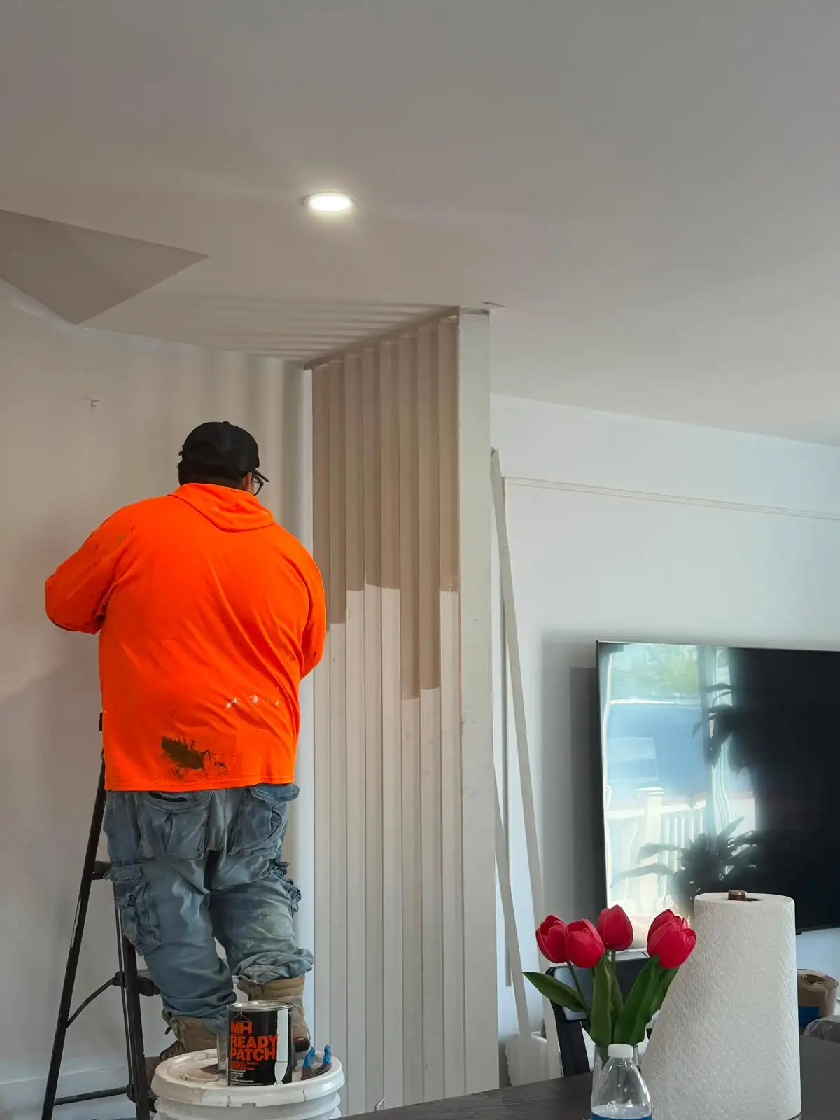 Crew installing vertical slat accent wall — Bath Beach, Brooklyn