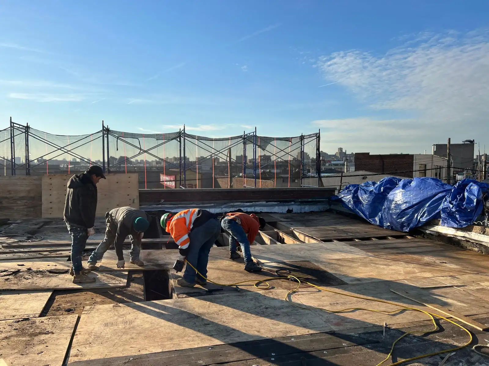 Crew removing burned roofing — Hunts Point, Bronx