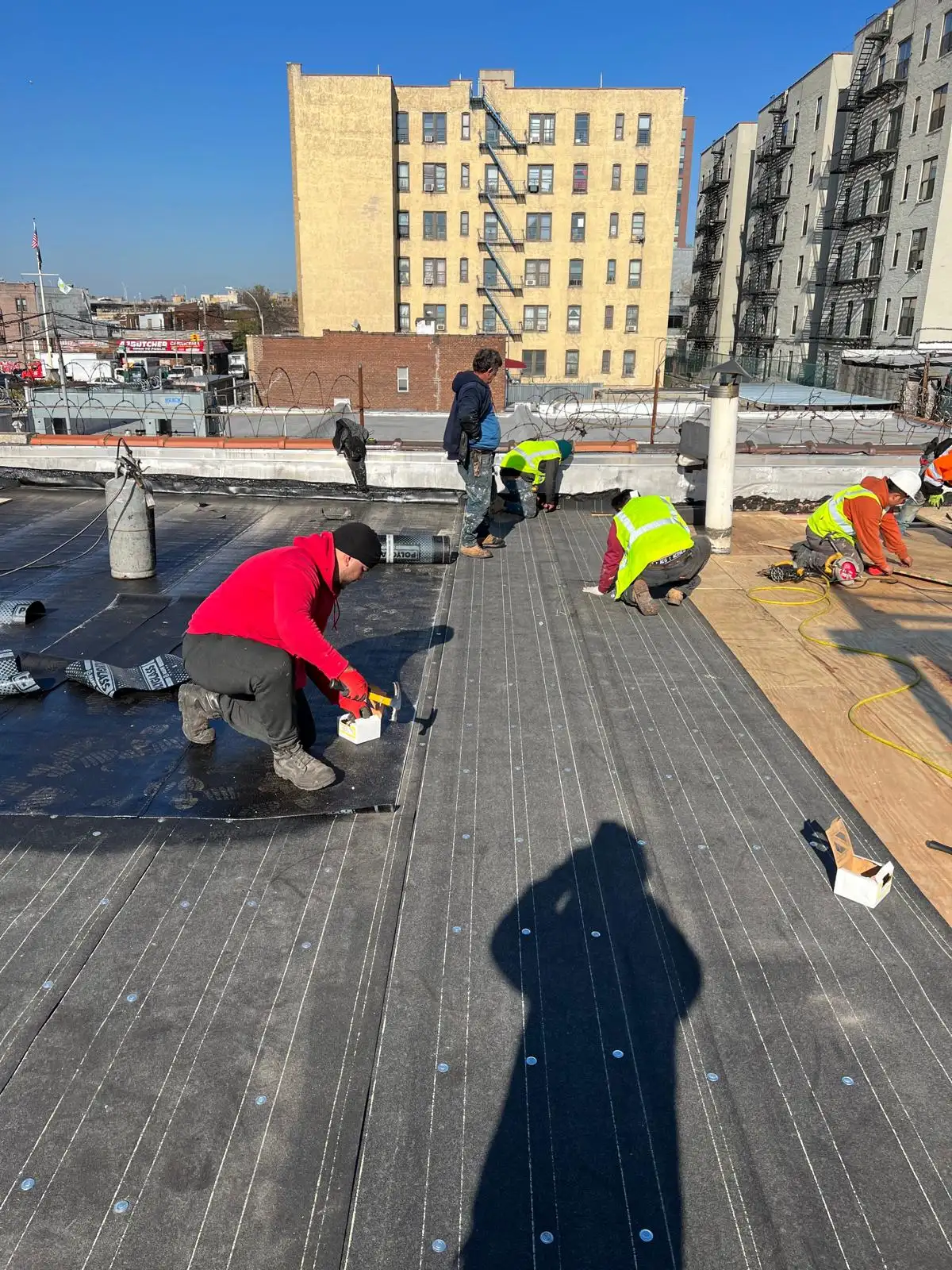 Crew removing damaged roof decking — Hunts Point, Bronx