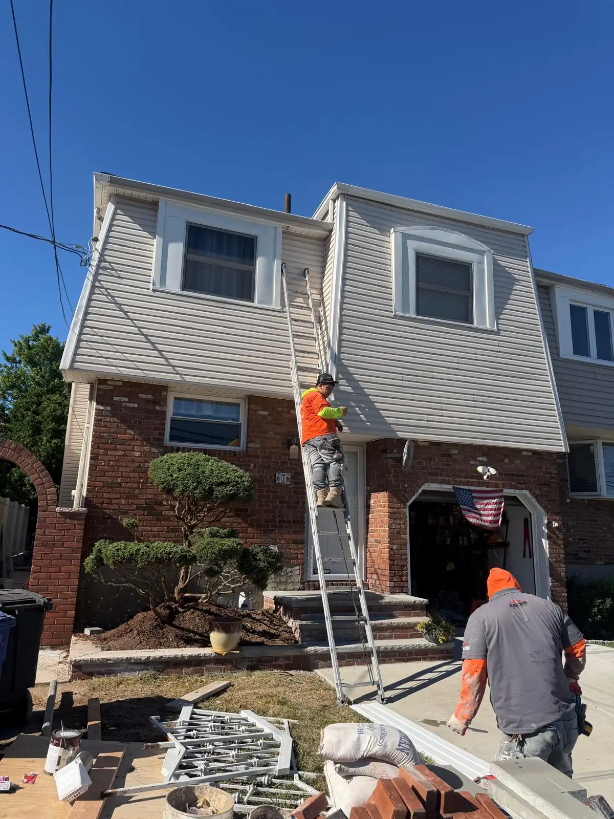 Crew repairing front exterior — Emerson Hill, Staten Island