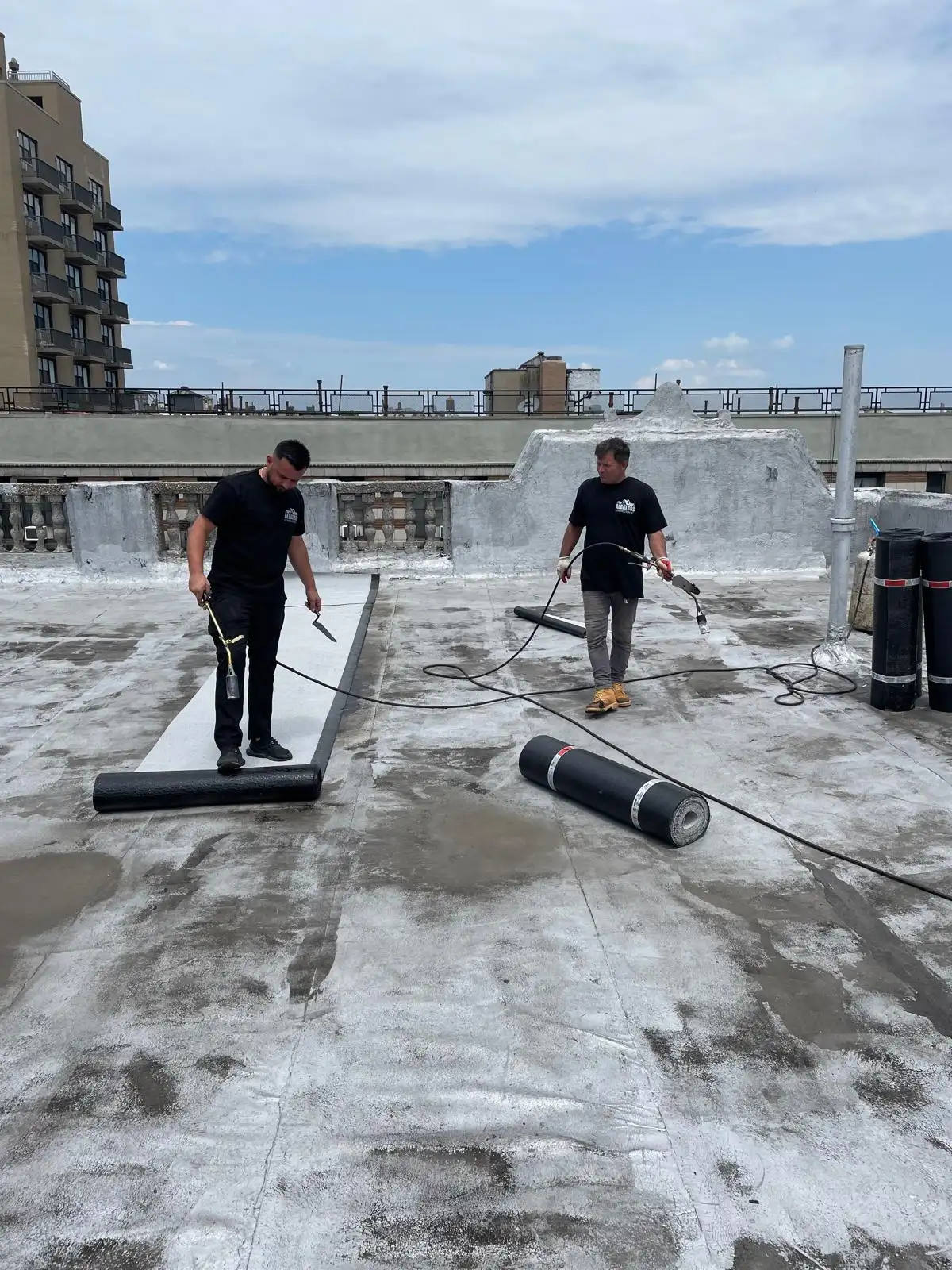 Crew rolling out SBS base sheet — Washington Heights, Manhattan