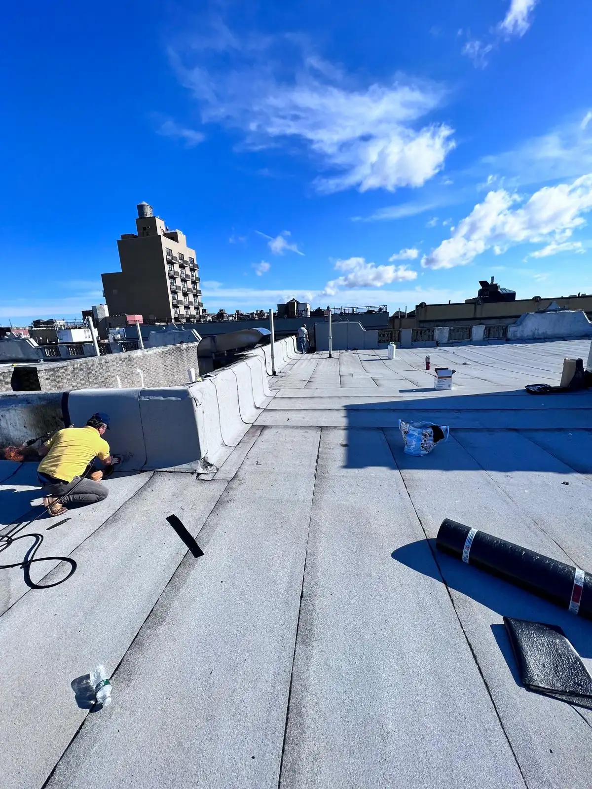 Crew rolling SBS membrane — Washington Heights, Manhattan