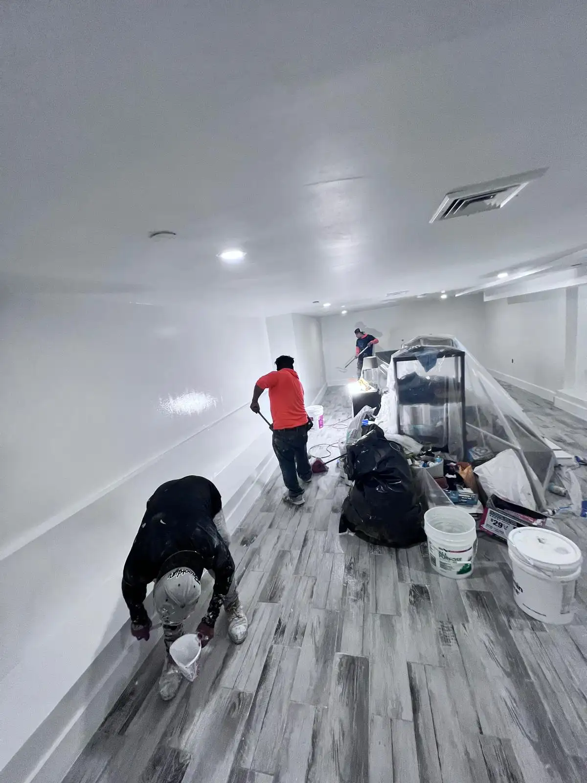Crew sanding basement walls — Bedford-Stuyvesant, Brooklyn