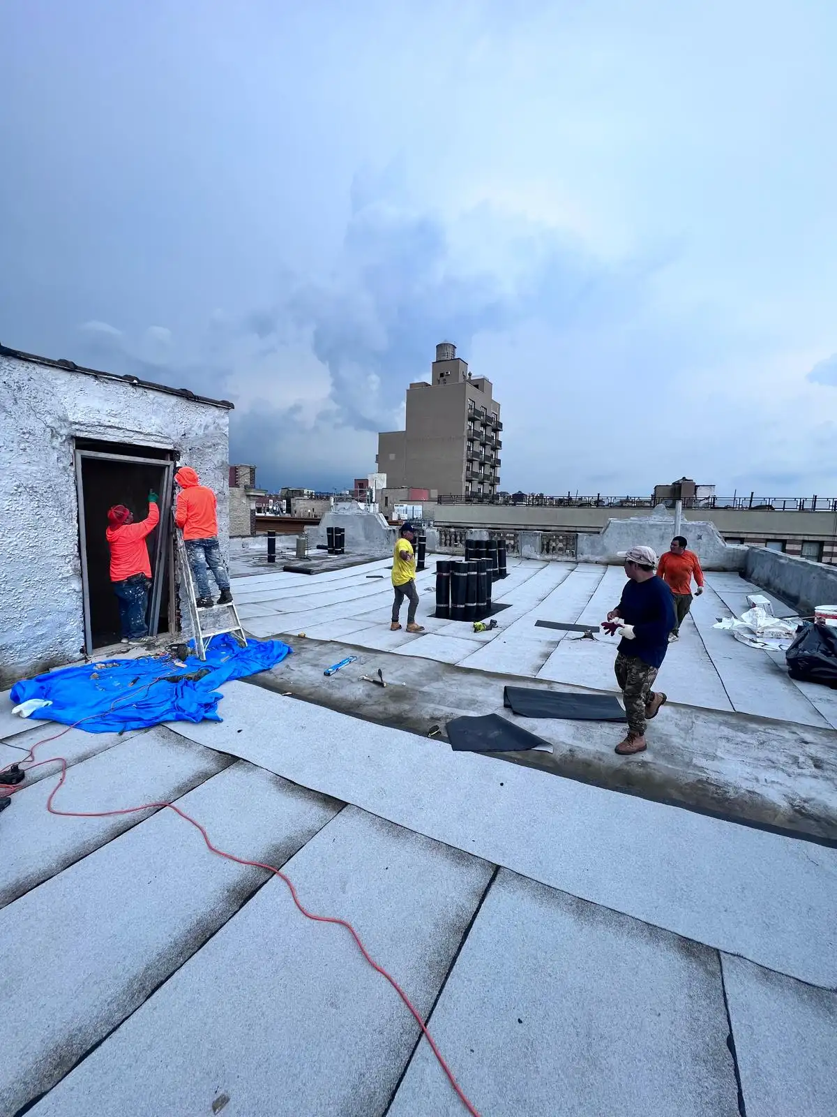 Crew working at roof bulkhead — Washington Heights, Manhattan