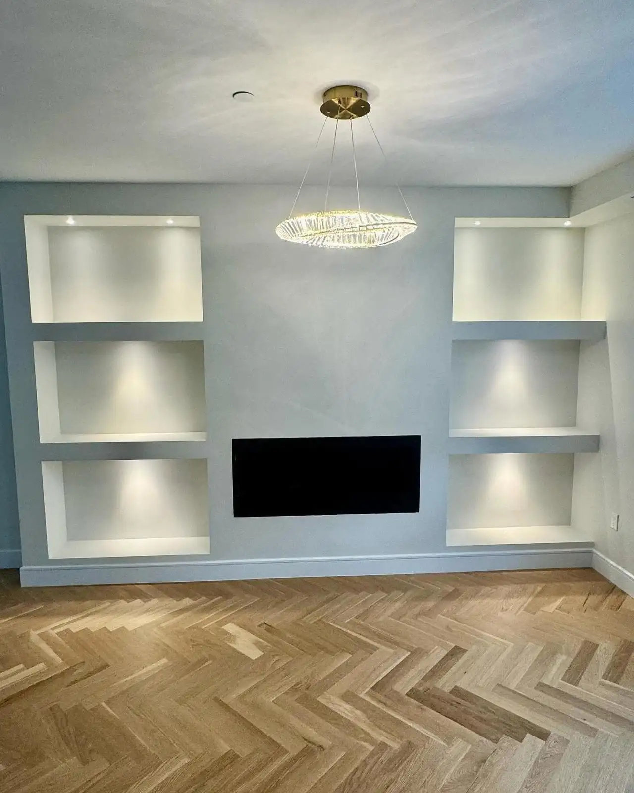 Custom TV wall with lit niches and herringbone floor — Arrochar, Staten Island