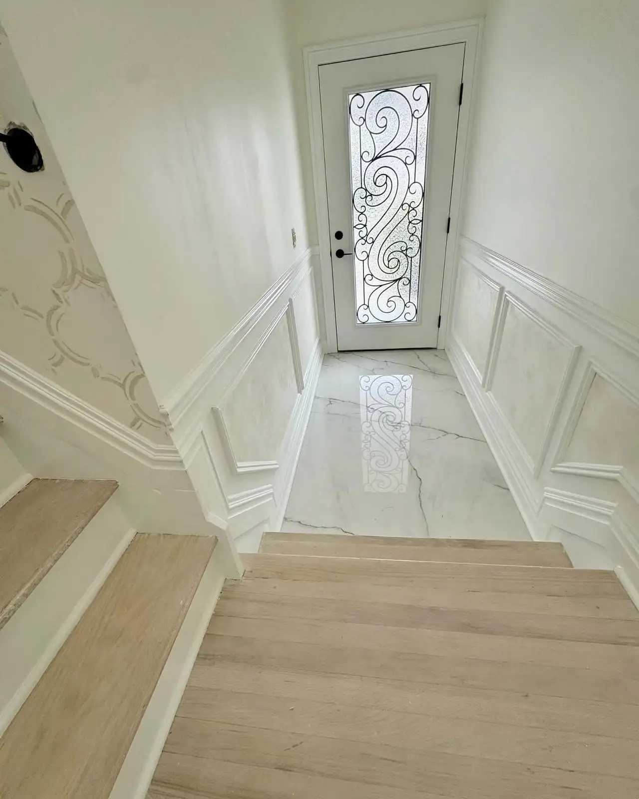 Entry foyer with marble-look tile and staircase molding — Arrochar, Staten Island