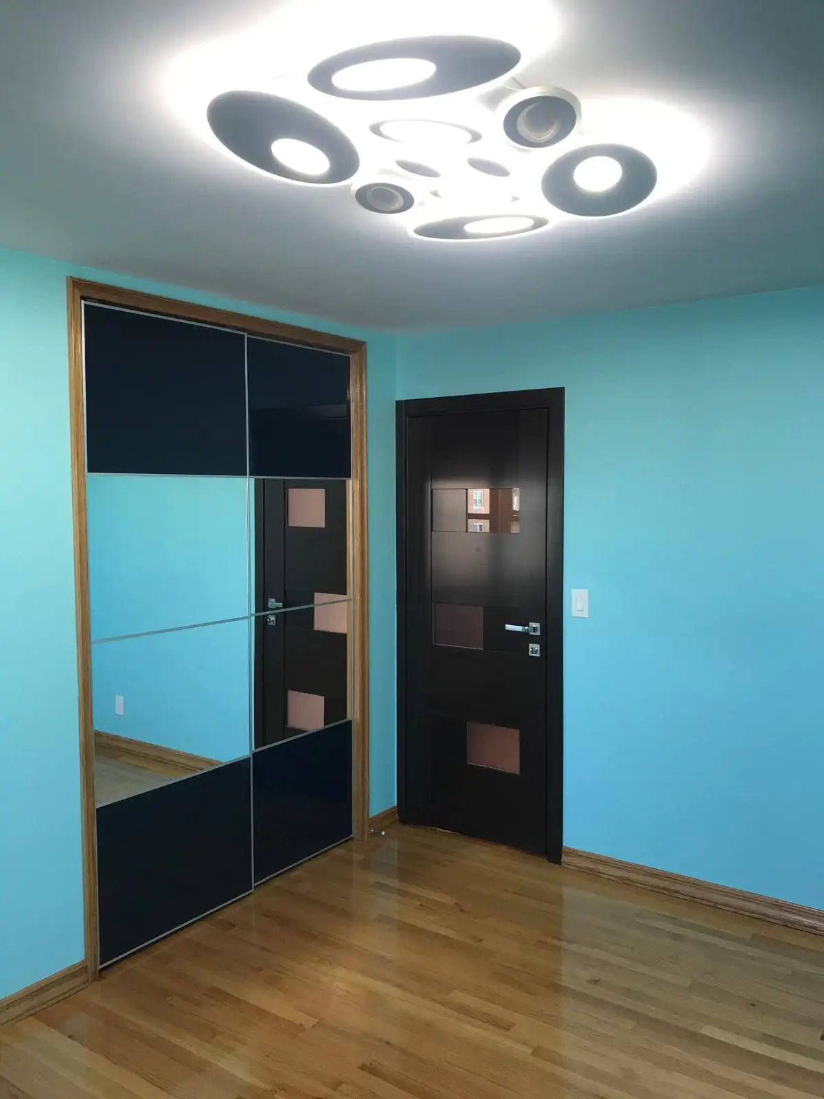 Entry with mirrored closet doors and modern light — Brighton Beach, Brooklyn
