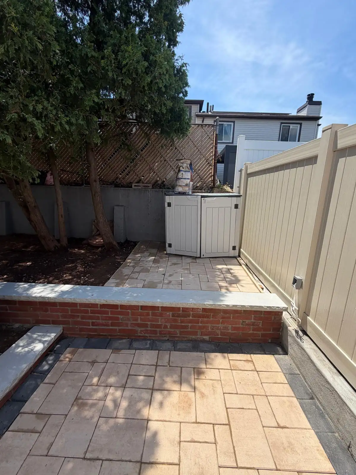 Finished backyard pavers and PVC fence — Emerson Hill, Staten Island