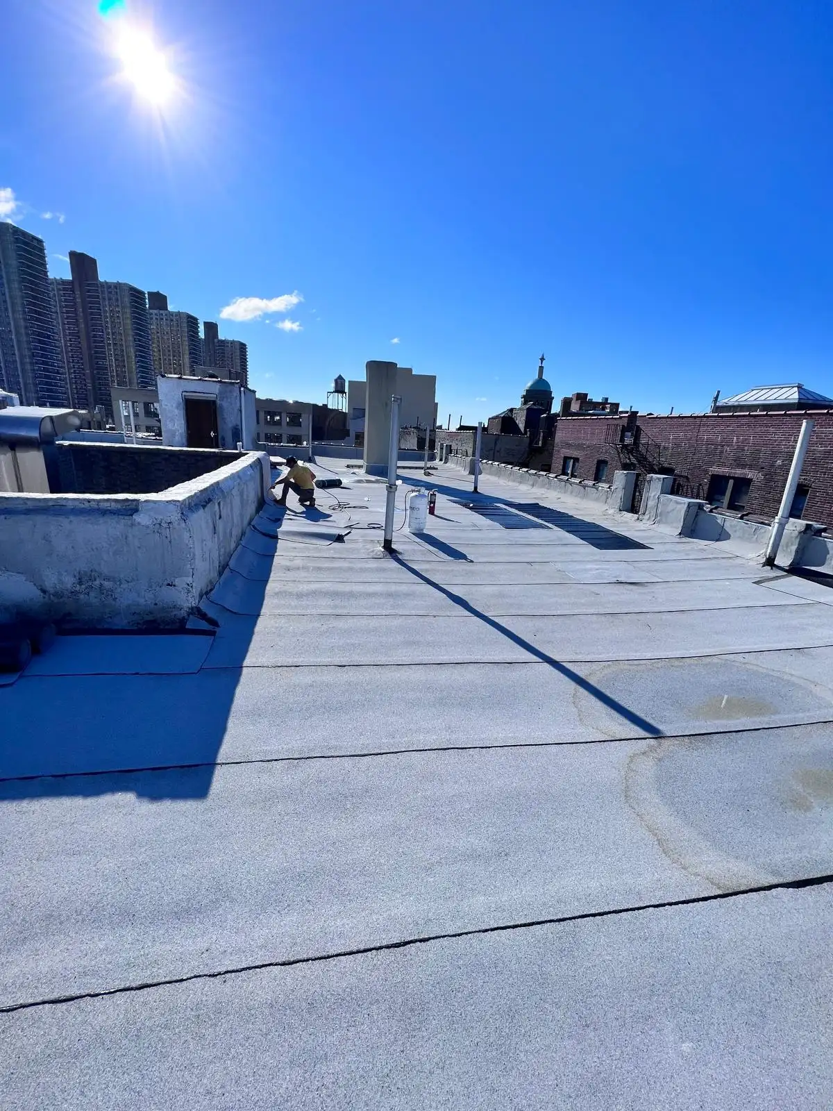 Finished roof under sunny sky — Washington Heights, Manhattan
