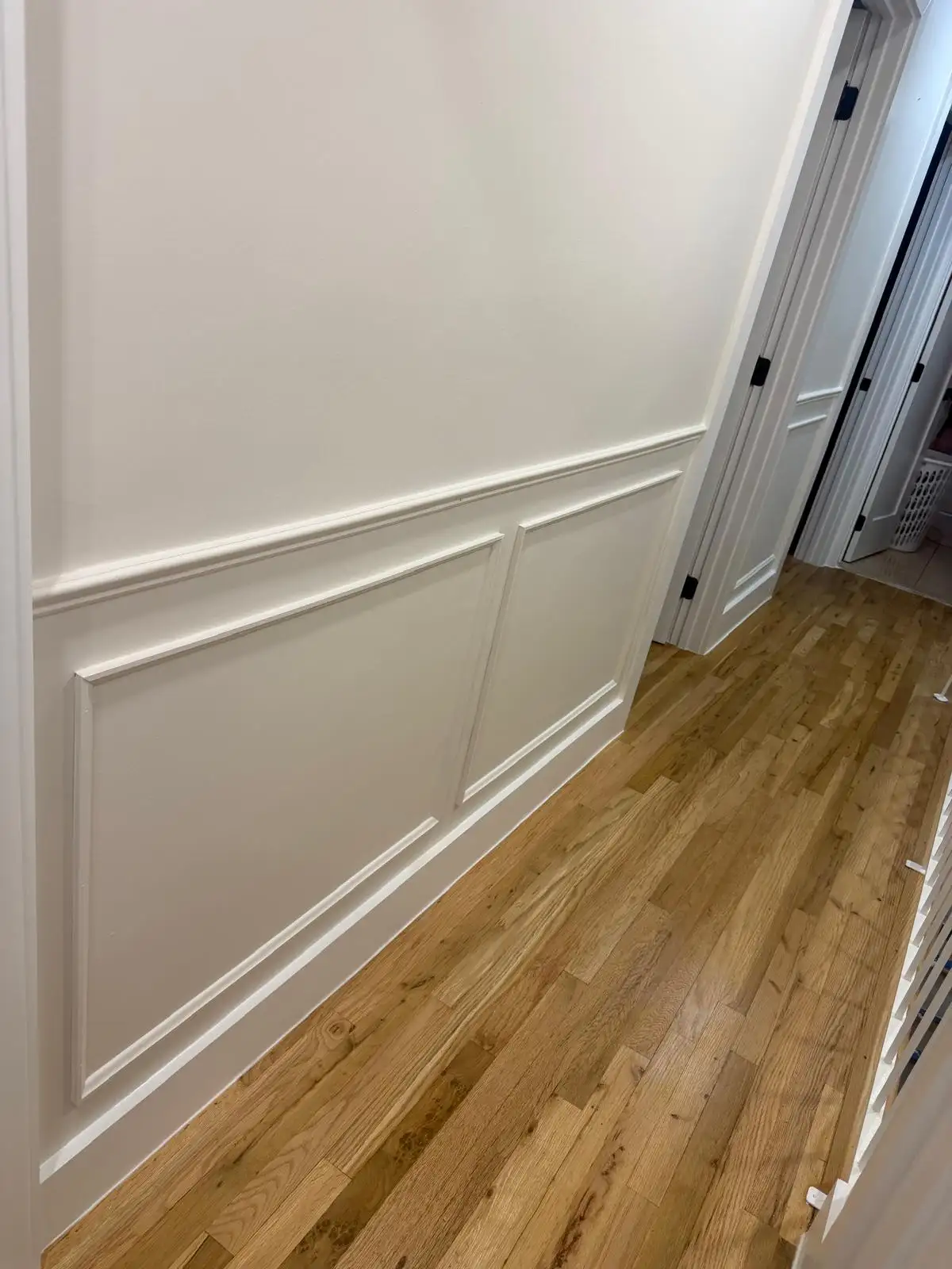 Hallway picture-frame molding and hardwood floor — Bath Beach, Brooklyn