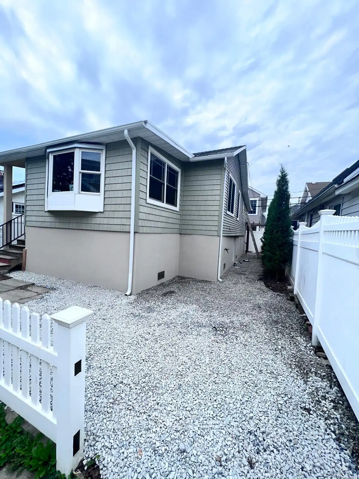 House exterior with new stucco and gravel — East Meadow, Long Island