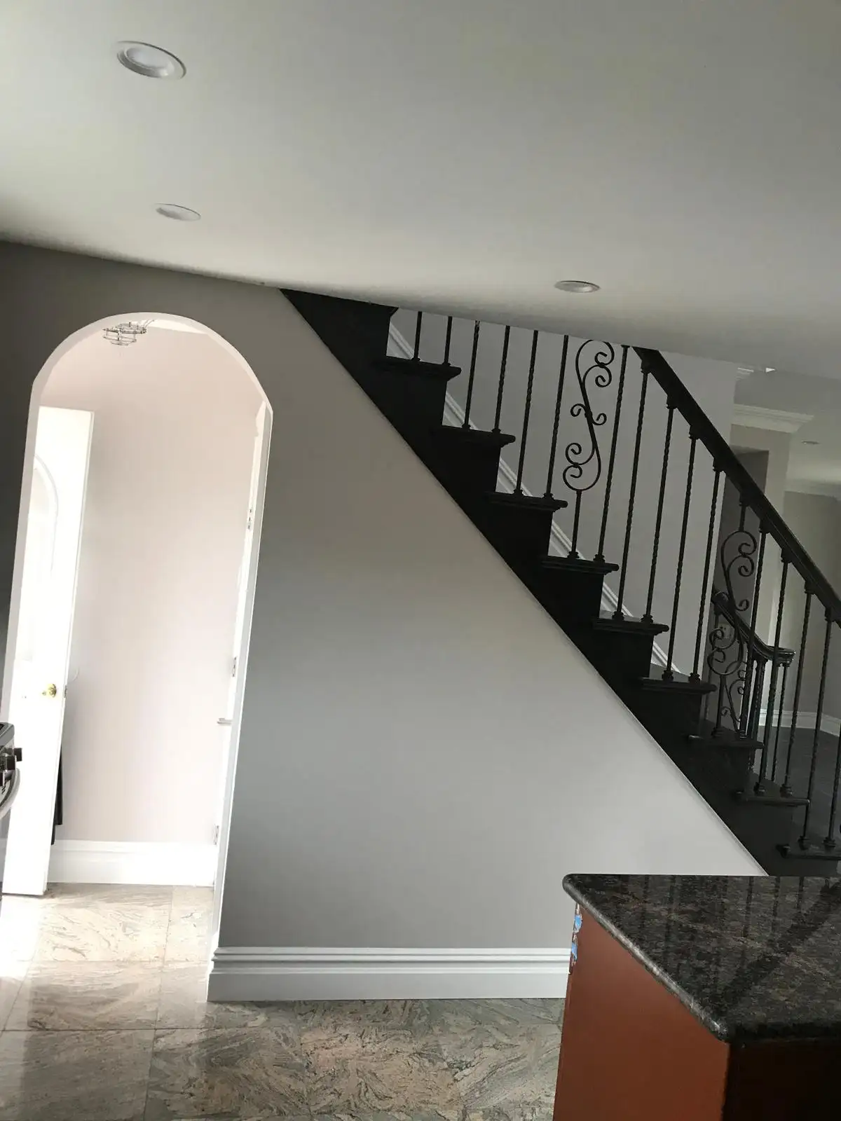 Interior staircase with iron railing and arched doorway — Great Kills, Staten Island