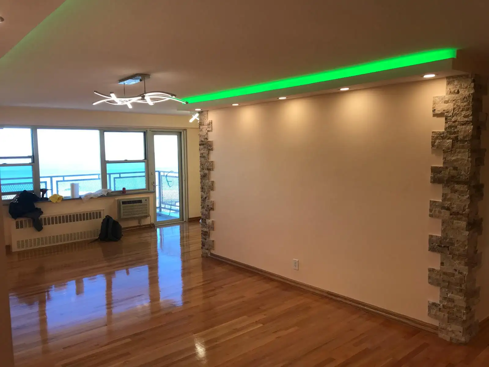Living room with LED cove ceiling and stone wall — Brighton Beach, Brooklyn