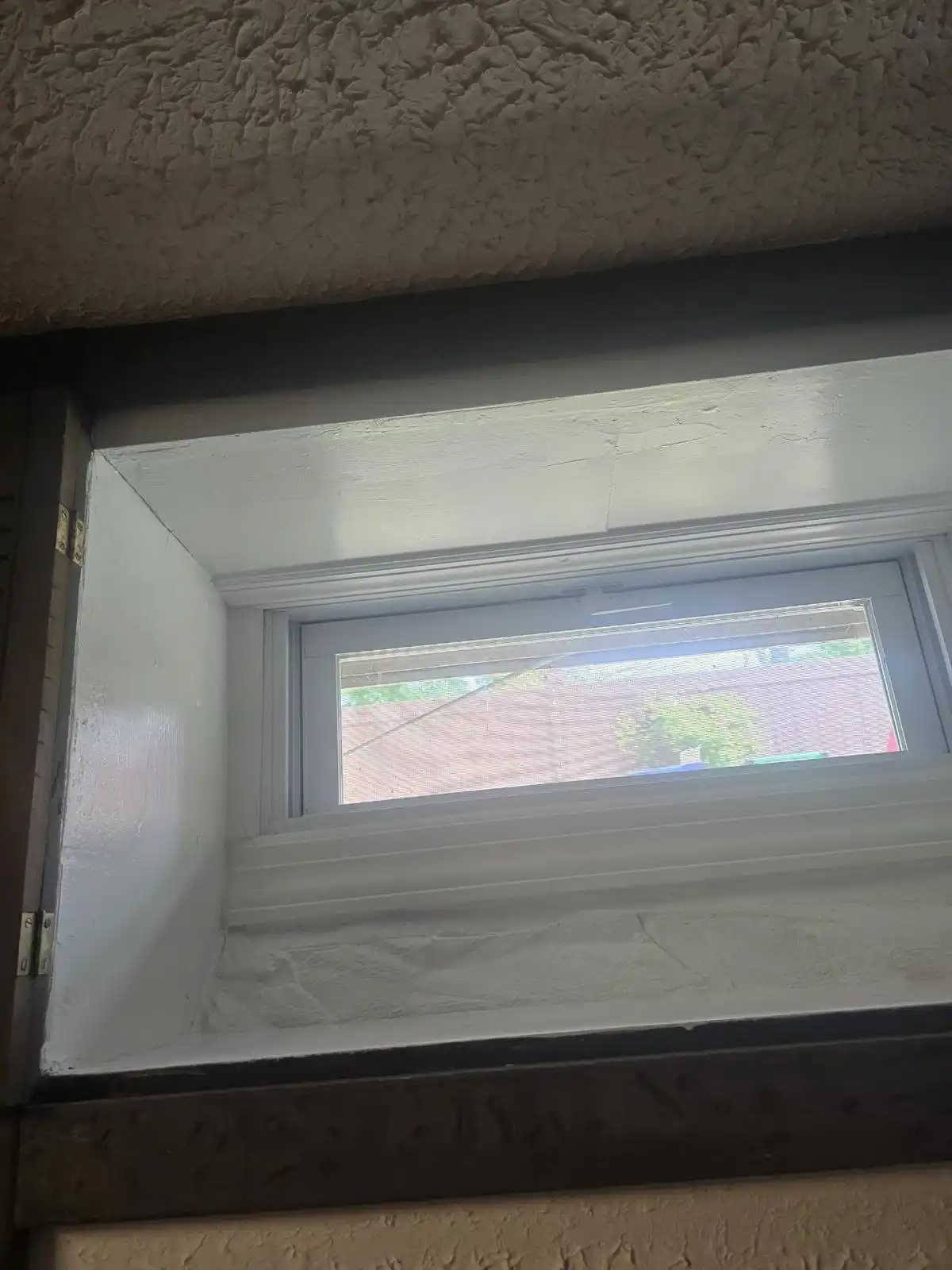 New basement window with sealed white frame — Eltingville, Staten Island