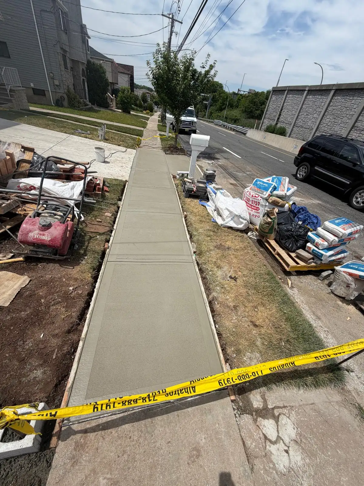 New concrete sidewalk curing — Emerson Hill, Staten Island