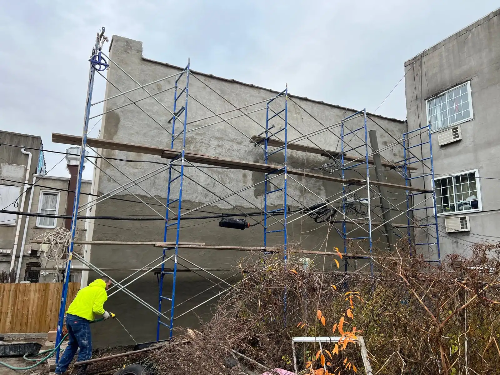 Pipe scaffolding on rear wall — East New York, Brooklyn