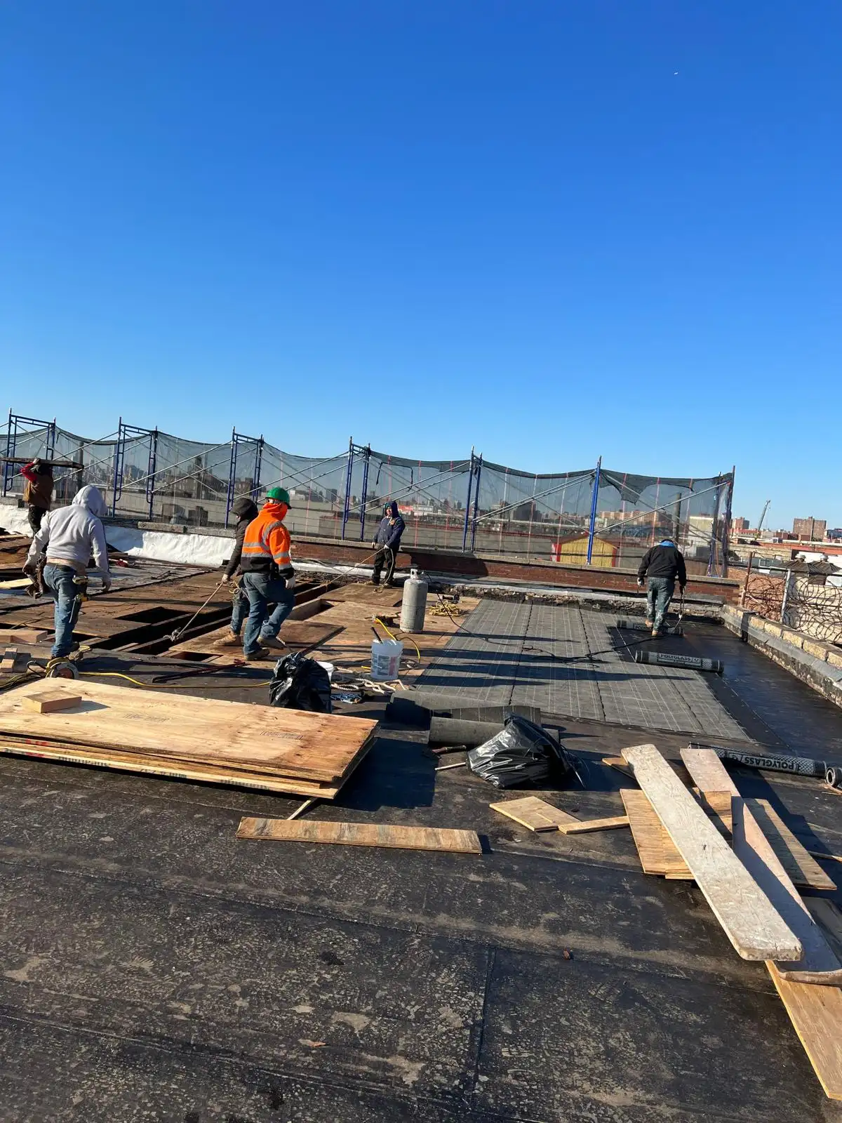 Roof insulation boards and crew — Hunts Point, Bronx