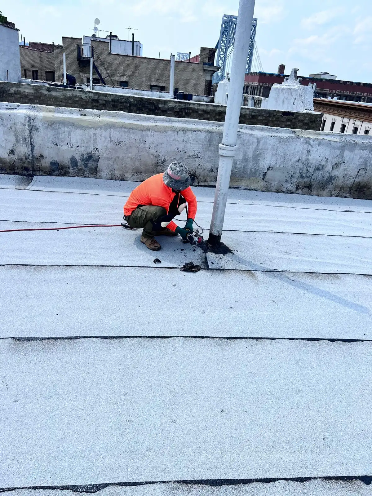 Roofer flashing pipe penetration — Washington Heights, Manhattan