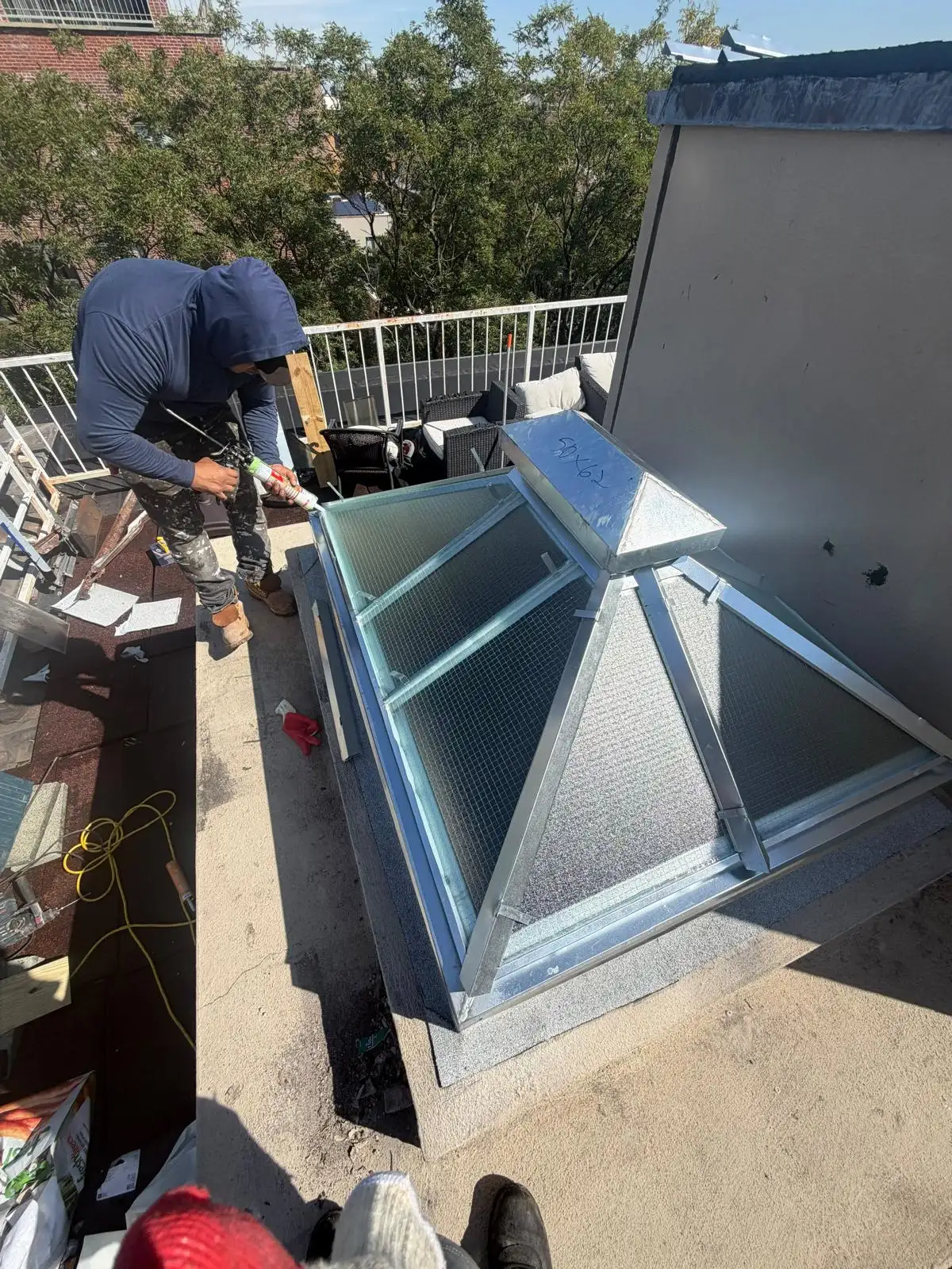 Roofer installing new skylight frame — South Slope, Brooklyn
