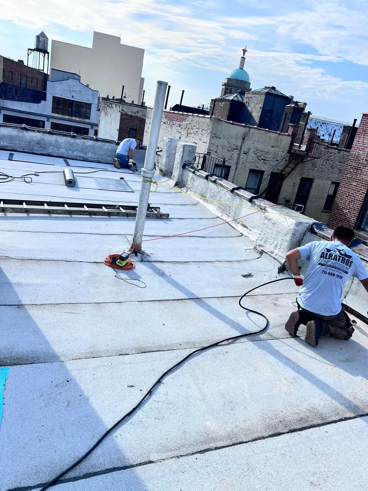 Roofer sealing roof penetrations — Washington Heights, Manhattan