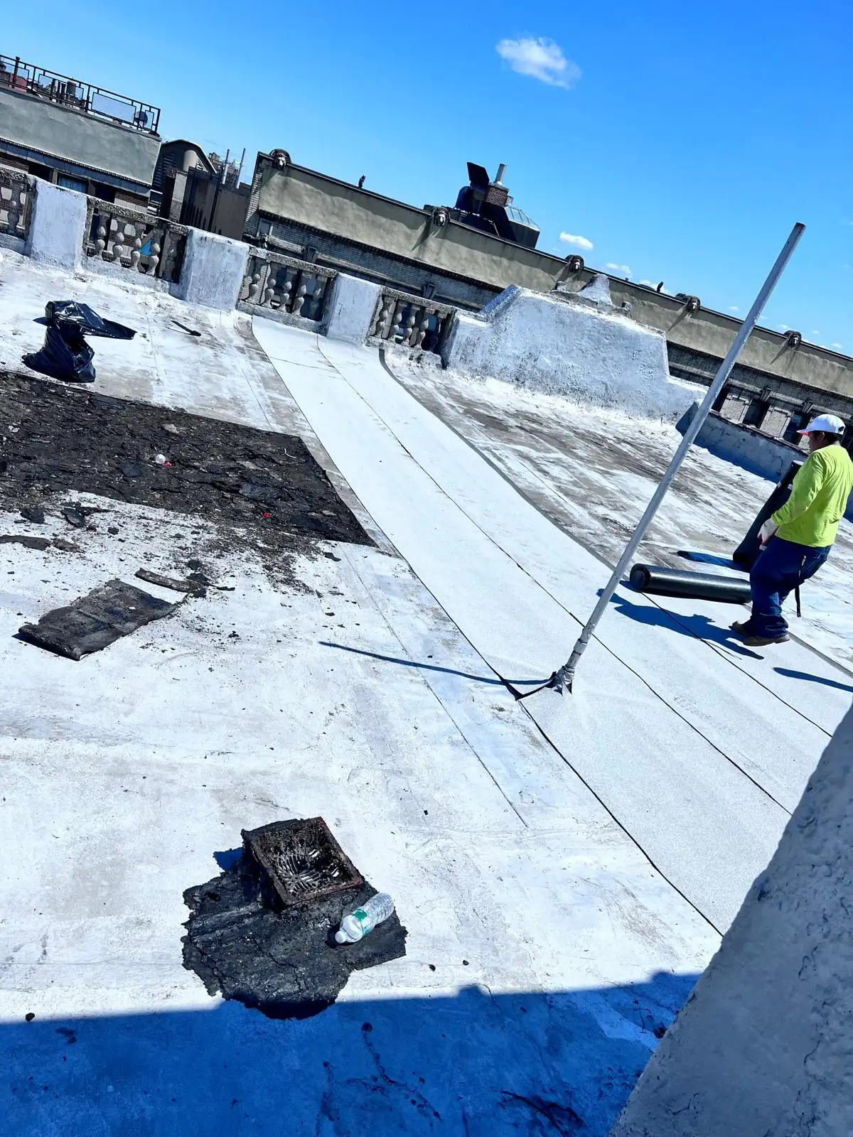 Roofer torching parapet flashing — Washington Heights, Manhattan