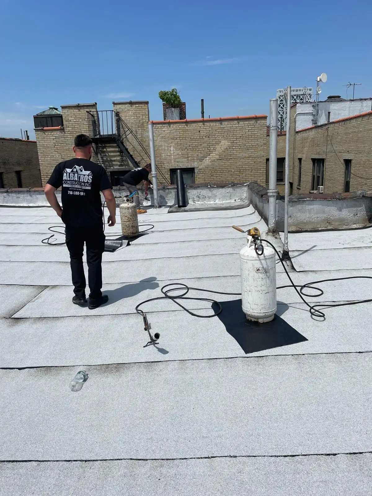 Roofer with torch and propane tank — Washington Heights, Manhattan