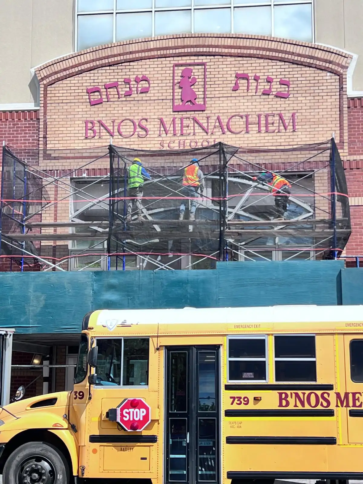Scaffolding at school facade with bus — Crown Heights, Brooklyn