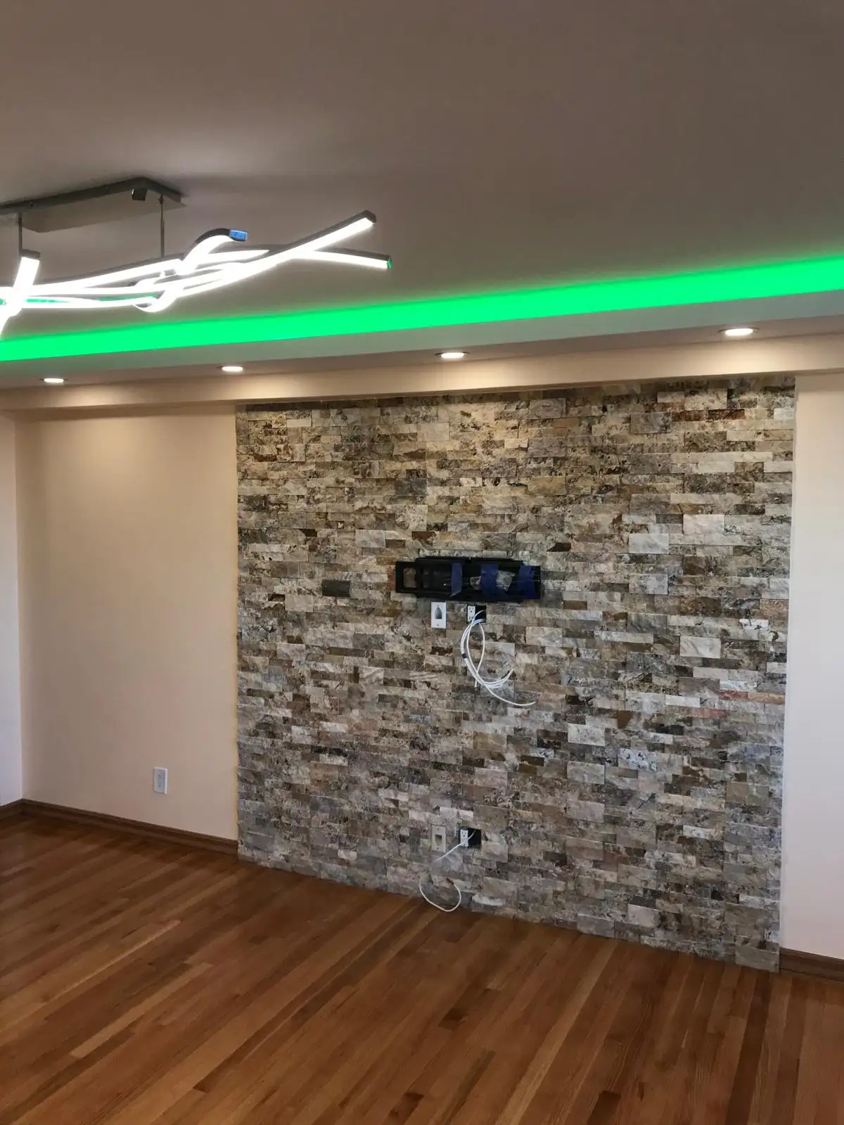 Stone accent wall with TV mount — Brighton Beach, Brooklyn