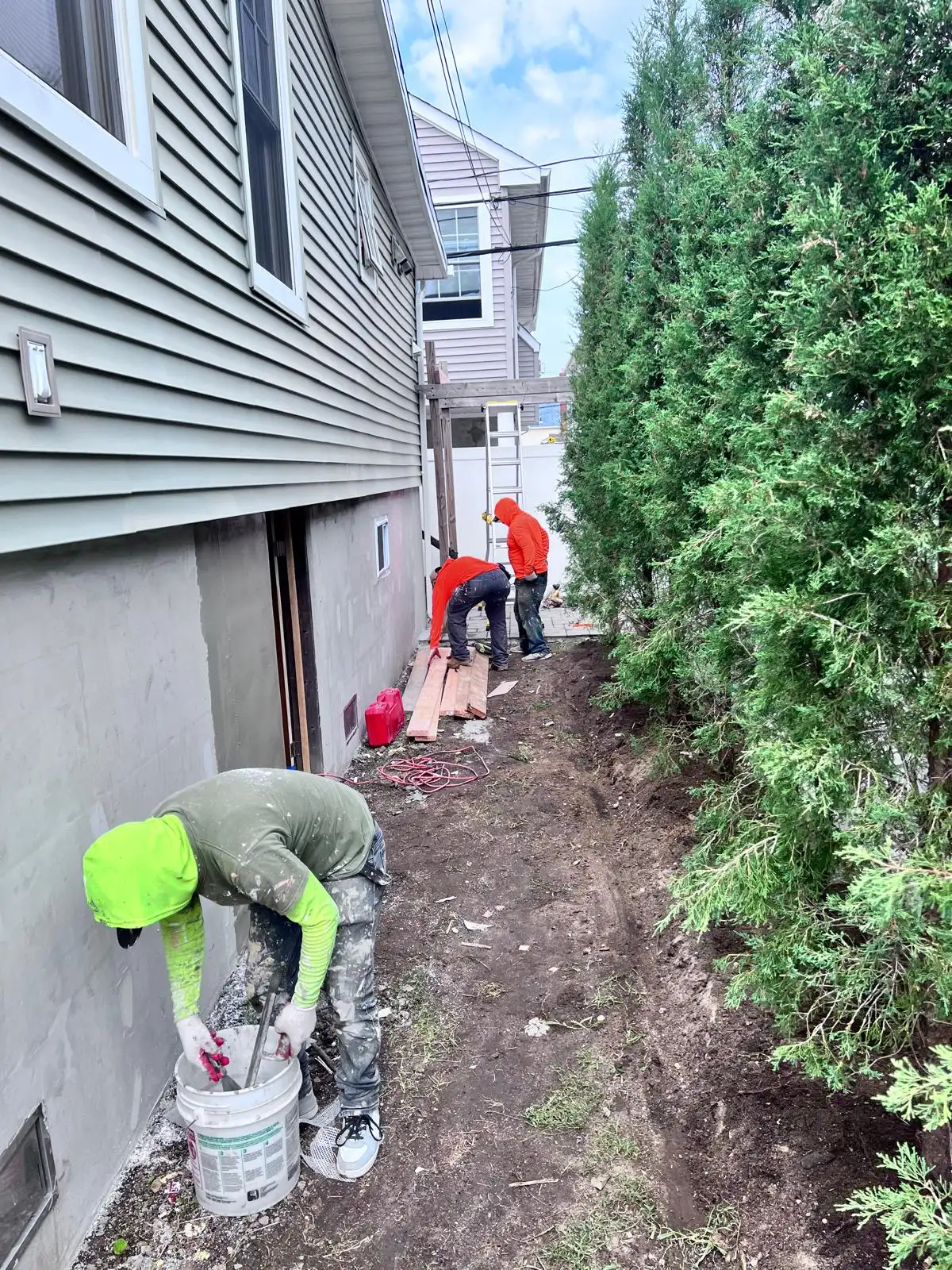 Stucco base coat along side of house — East Meadow, Long Island