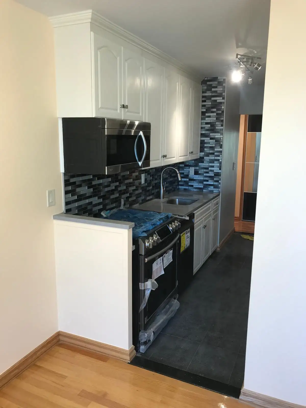 White shaker kitchen with granite counters — Brighton Beach, Brooklyn